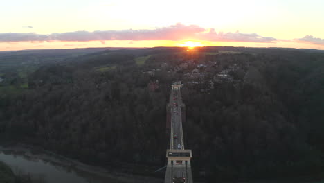 Pulling-away-aerial-shot-of-Clifton-suspension-bridge-in-the-city-of-Bristol-on-the-River-Avon-at-sunset