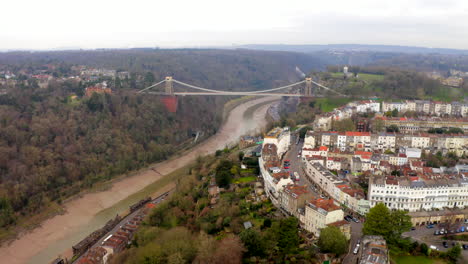 An-aerial-shot-flying-towards-the-Clifton-suspension-bridge-and-the-city-of-Bristol-from-on-a-cloudy-day