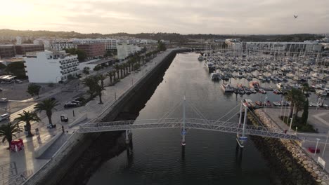Broll-cinematic-aerial-view-of-the-lift-bridge-and-boatyard-at-Marina-de-Lagos-Algarve-Portugal