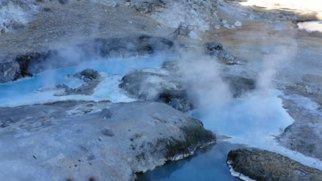 Hot-Springs-at-Hot-Creek-Geological-Site,-Famous-Landmark-in-Inyo-National-Forest,-US,-Aerial-Circling