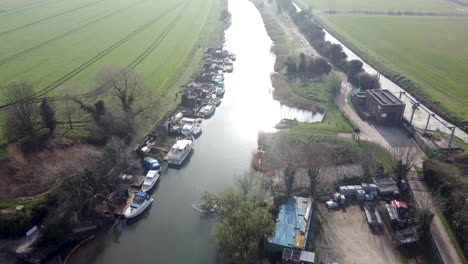 Aerial-drone-shot-of-boats-docked-in-the-River-Stour-in-Kent,-England