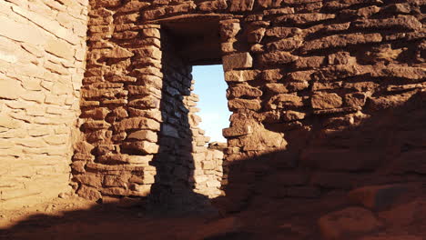 Forward-diagonal-dolly-zoom-inside-old-ruins-of-Wukoki-Pueblo