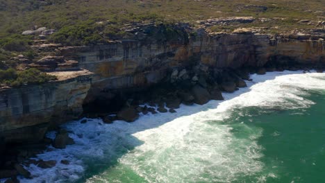 Ocean-Coastline-With-Breaking-Waves-On-Cliffside-At-Royal-National-Park-In-Sydney,-New-South-Wales,-Australia