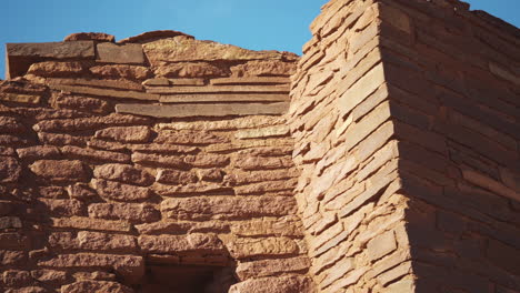 Looking-up-at-old-ruins-of-Wukoki-Pueblo-on-beautiful-day