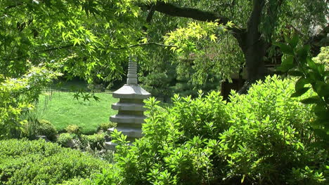 Stone-pagoda-seen-amidst-trees-and-greenery-in-a-Japanese-garden