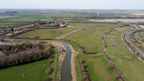 Aerial-drone-shot-of-the-River-Stour-in-Kent,-England-with-marshlands