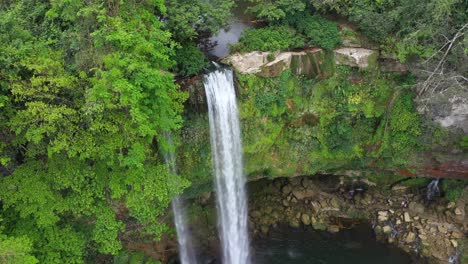 Aerial:-tropical-waterfall-cascading-over-rocky-canyon-precipice