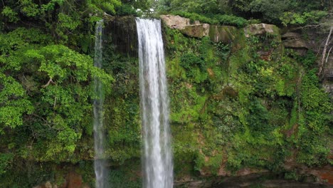 Aerial-shot-of-Misol-Há-waterfall-in-Mexico,-rising-view-of-beautiful-waterfall