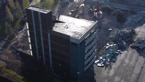 Demolished-multi-storey-car-park-concrete-construction-debris-in-town-regeneration-aerial-rear-view-over-demolition-site