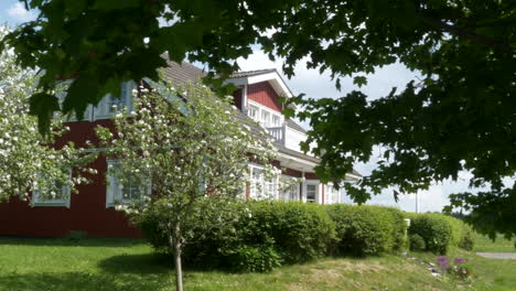Typical-idyllic-Nordic-house-and-beautiful-garden-with-maple-tree