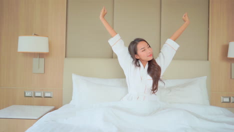 Asian-Woman-wake-up-in-a-hotel-room-in-the-morning