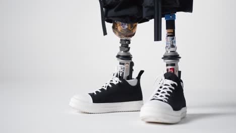 Disabled-with-two-prosthetic-artificial-legs-in-sports-shoes-walking-in-then-out