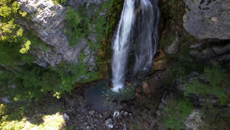 Waterfall-in-Albanian-alp-rocky-mountain-slope,-water-falling-from-cliffs