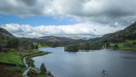 Lake-District,-Rydal-Water,-Unesco-World-Heritage,-Time-lapse,-Looking-over-Lake-with-clouds-scudding-with-light-and-shadows-on-scene