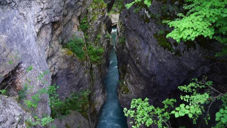 Emerald-water-of-mountain-river-streaming-through-high-cliffs-of-canyon-in-Albania