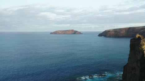 Flying-past-wild-cliffs-of-Ilhéu-da-Cal-part-of-Porto-Santo-in-Atlantic-Ocean