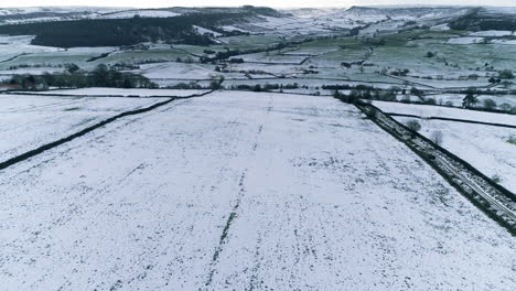 North-York-Moors-Snow-Scene-Drone-Flight,-Castleton,-Westerdale,-Rosedale,-Flight-over-Danby-Dale-from-Oakley-Walls,-Winter-cold-and-moody-clouds,-Phantom-4,-Clip-8