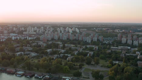 Aerial-view-of-residential-buildings-near-the-river-in-the-outskirts-of-Belgrade-during-the-sunset