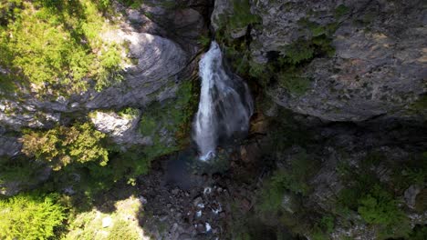 Wild-creek-falling-from-rocky-slope-of-mountain-into-canyon-creating-beautiful-waterfall-of-Grunasi-in-Albania