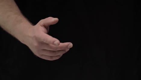 male-hands-on-a-black-background