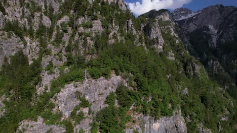 Wilderness-mountains-in-Albanian-Alps,-rocky-slope-and-pine-trees-on-the-top-of-cliffs