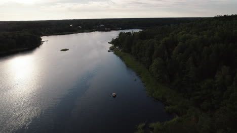 Tranquil-nature,-Swedish-Archipelago,-Boat-in-a-calm-bay-and-island,-drone