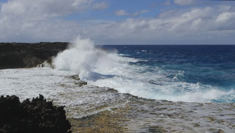 Huge-waves-crashing-against-rocky-cliffs,-Isle-of-Pines,-New-Caledonia,-slow-motion