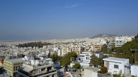 Low-aerial-shot-pushing-past-buildings-over-Athens-Greece,-4K