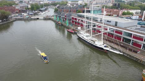 Bristol-city-Waterfront-docks-pleasure-boat-cursing-along-river-UK-Aerial-footage-4K