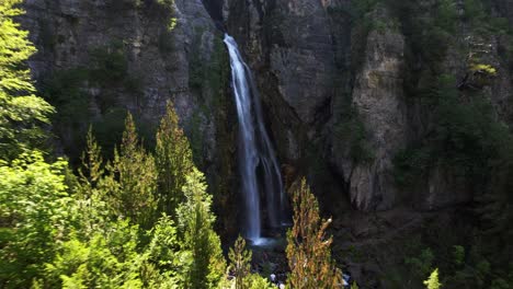 Filmische-Enthüllung-Eines-Wunderbaren-Wasserfalls-Auf-Einem-Felsigen-Berg-Gegen-Waldbäume-In-Teth,-Albanien