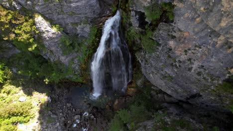 Beautiful-waterfall-on-rocky-slope-of-mountain-in-Albanian-Alps-visited-by-tourists