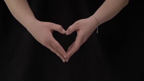 Female-hands-on-a-black-background