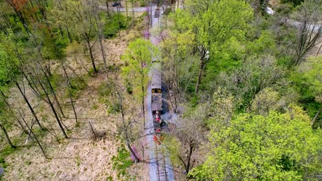 An-Aerial-View-of-an-1860's-Steam-Passenger-Train-Traveling-Thru-a-Wooded-Area-on-a-Lonely-Single-Rail-Road-Track