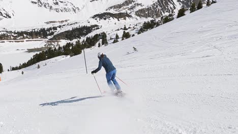 Female-skier-skiing-downhill-on-a-steep-ski-slope-in-the-austrian-mountains
