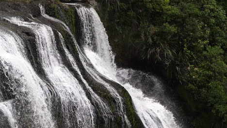 Cascade-Waterfall-splashing-on-rocks-and-plants-of-dense-Jungle-in-New-Zealand---Waihi-Falls,NZ