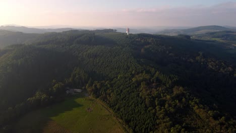 Luftaufnahme-Der-5g-Tower-Basis-Telekomstation-In-Einem-Abgelegenen-Gebiet-Auf-Der-Spitze-Des-Hügels-In-Wilden-Immergrünen-Waldbäumen-Während-Des-Sonnenuntergangs