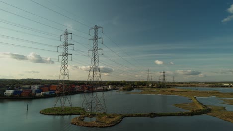High-Voltage-Electrical-Towers-On-Water-Landscape-In-Southampton,-UK