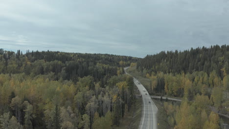 Aerial-static-view-of-traffic-on-road-running-through-British-Columbia-forest