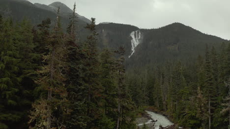Distant-View-Of-Cascade-On-Steep-Forest-Valley-In-Odegaard-Falls,-Bella-Coola,-British-Columbia,-Canada