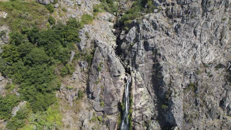 Aerial-top-down-view-of-big-natural-waterfall-named-"Frecha-da-Mizarela"-at-Serra-da-Freita
