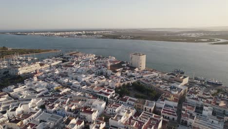 Ayamonte,-Spain:-Orbiting-shot-above-traditional-white-buildings-on-seaside