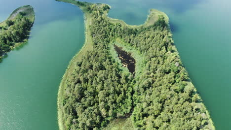 Beautiful-lake-island-with-water-pond-inside,-aerial-drone-view