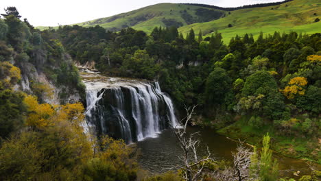 Picturesque-landscape-with-Waihi-Falls-and-green-hills-in-background---National-Park,New-Zealand---Wide-shot
