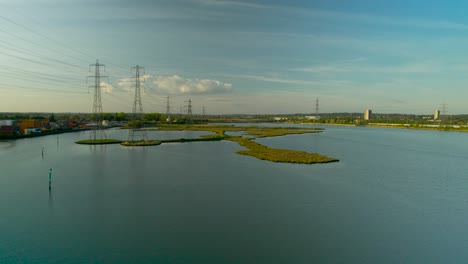 Low-level-aerial-over-Southampton-wetlands-in-England-showing-miles-of-high-voltage-transmission-towers