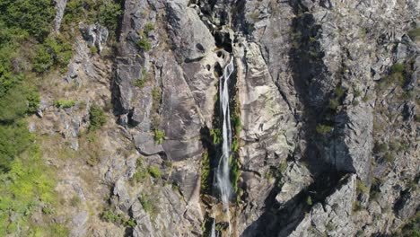 Aerial-zoom-in-of-natural-waterfall-named-"Frecha-da-Mizarela"-at-Serra-da-Freita