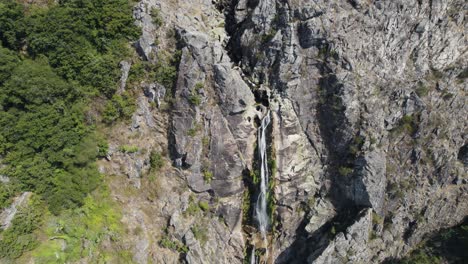 Aerial-descending-towards-magnificent-waterfall-High-stone-Cliff---Mizarela