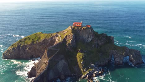 Gaztelugatxe-medieval-old-hermitage-for-pilgrims-located-in-Basque-Country-north-of-Spain,-aerial-view-at-sunset