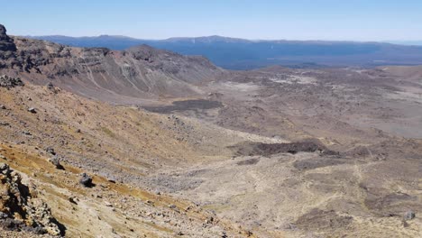 Expansive-vista-of-volcanic-rock-and-ash,-panning-from-mountain-summit