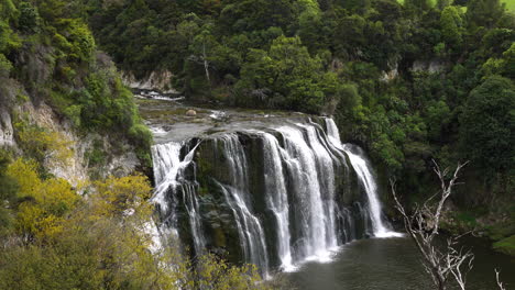 Aerial-shot-of-large-Waihi-Waterfall-surrounded-by-green-scenery-in-New-Zealand-Reserve---Wide-shot