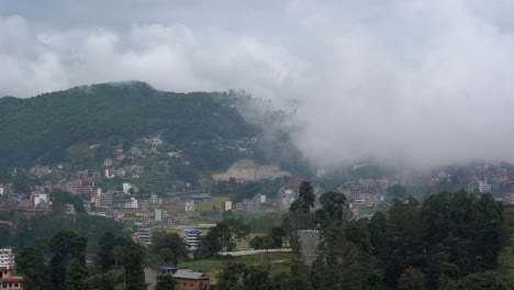 Clouds-drifting-over-the-mountains-and-into-the-lush-green-valley-and-over-the-small-town